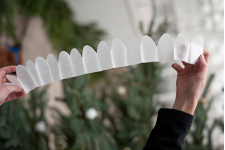 5. Vik ut remsan. För att få vacker form på rosen formar man blombladen i handflatan genom att trycka på varje blomblad med tummen så de blir kupiga.